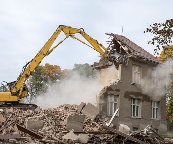 Machinery Demolishing Building